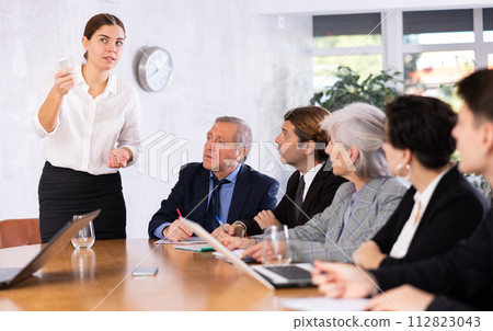 Young business woman making slideshow presentation for partners in office Young business woman making slideshow presentation for partners in office 112823043