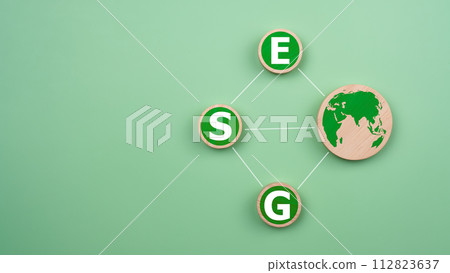 ESG concepts for sustainable environment, society and governance Businesses are environmentally responsible, A circular wooden board with the abbreviation ESG printed on a green background. 112823637