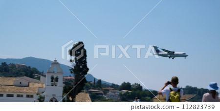 Monastery on the water, over which planes take off and land Greece Corfu island Vlacherna Monastery  112823739
