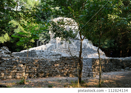 Ruins of Great Basilica in Butrint National Park, Buthrotum, Albania. Triconch Palace at Butrint Life and death of an ancient Roman house Historical medieval Venetian Tower surrounded. High quality 112824134