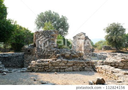 Ruins of Great Basilica in Butrint National Park, Buthrotum, Albania. Triconch Palace at Butrint Life and death of an ancient Roman house Historical medieval Venetian Tower surrounded. High quality 112824156