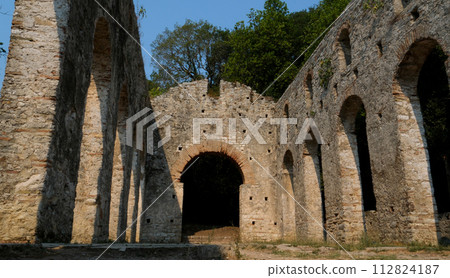 Ruins of Great Basilica in Butrint National Park, Buthrotum, Albania. Triconch Palace at Butrint Life and death of an ancient Roman house Historical medieval Venetian Tower surrounded. High quality Ruins of Great Basilica in Butrint National Park, Buthrotum, Albania. Triconch Palace at Butrint Life and death of an ancient Roman house Historical medieval Venetian Tower surrounded. High quality 112824187