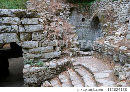 Ruins of Great Basilica in Butrint National Park, Buthrotum, Albania. Triconch Palace at Butrint Life and death of an ancient Roman house Historical medieval Venetian Tower surrounded. High quality 112824188