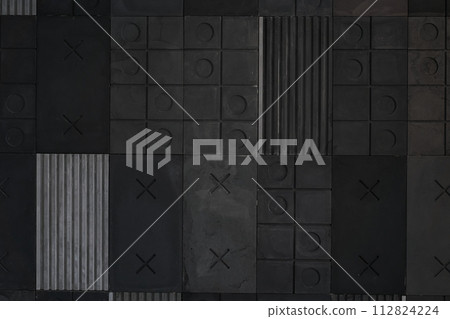 Textured gray, black geometric background made of concrete, paste with stripes, squares, circles, crosses, tic-tac-toe, copy space. Concept of abstract modern wall design with bulky convex elements Textured gray, black geometric background made of concrete, paste with stripes, squares, circles, crosses, tic-tac-toe, copy space. Concept of abstract modern wall design with bulky convex elements 112824224