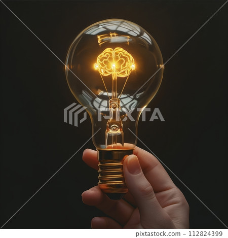 A human hand holds a light bulb glowing with a brain shape, representing creativity, innovation, and inspiration. A human hand holds a light bulb glowing with a brain shape, representing creativity, innovation, and inspiration. 112824399