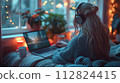 A woman enjoys a relaxing evening, listening to music on her headphones while using a laptop by a festive window. The comforts of home, Relaxation Activities and Digital Nomad Concept 112824415