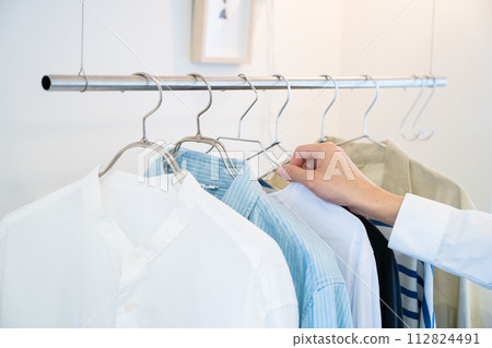 Men's clothes and hands on hangers 112824491