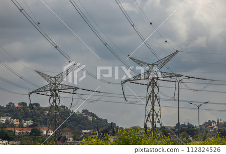 electric pole with wires against a dramatic sky 112824526