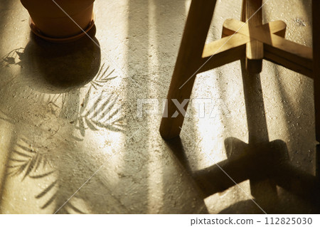 Comfortable rest by the sunny window. A background with sunlight and shadows that can be used in various designs. 112825030