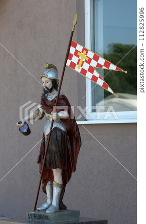 The statue of St. Florian patron of firefighters in front of the fire department Kosnica in Petina, Croatia 112825996