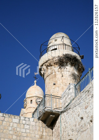 The Benedictine Dormition Abbey bell tower stands parallel to a Muslim mosque minaret built atop the the King David's Tomb in Jerusalem, Israel The Benedictine Dormition Abbey bell tower stands parallel to a Muslim mosque minaret built atop the the King David's Tomb in Jerusalem, Israel 112826157