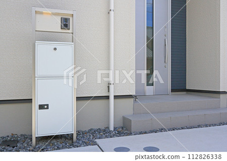 Delivery box installed at the entrance of a house Delivery box installed at the entrance of a house 112826338