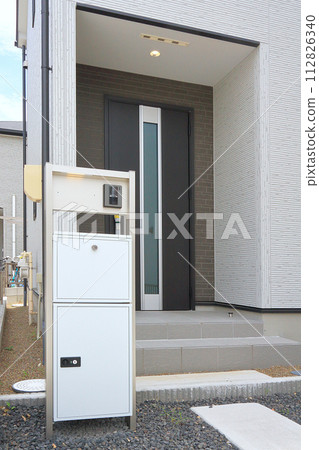 Delivery box installed at the entrance of a house Delivery box installed at the entrance of a house 112826340