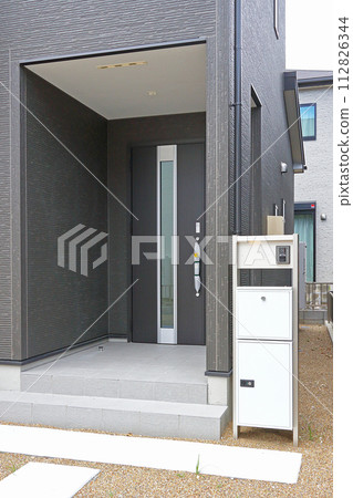 Delivery box installed at the entrance of a house Delivery box installed at the entrance of a house 112826344