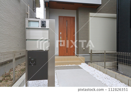 安裝在房屋入口處的送貨箱 112826351