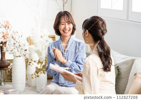 A woman giving a gift 112827208