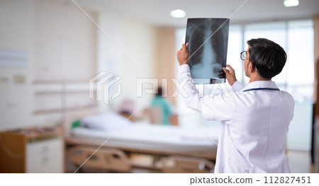 Doctor checking chest x-ray film in hospital 112827451