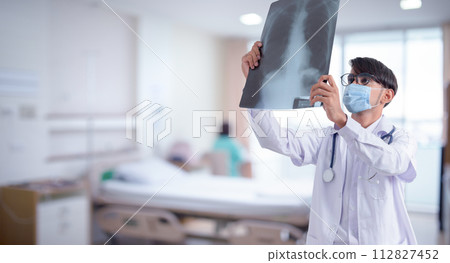 Doctor checking chest x-ray film in hospital 112827452