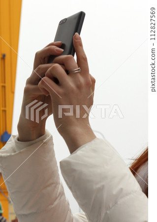 Hands of woman with phone 112827569