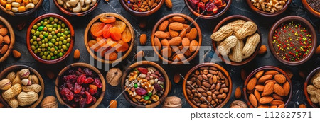 Assorted nuts and dried fruit. Organic food in wooden bowls. Assorted nuts and dried fruit. Organic food in wooden bowls. 112827571
