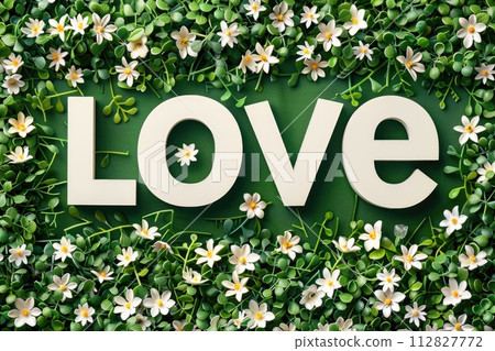 White love text on green floral background 112827772