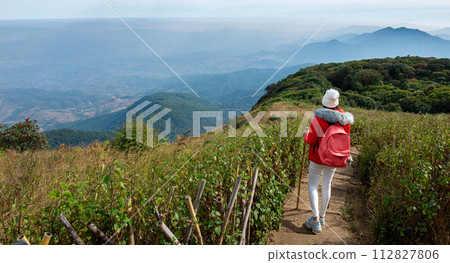 Asian female hiker hiking on nature trail Asian female hiker hiking on nature trail 112827806
