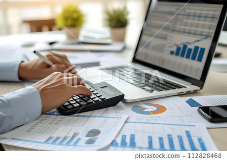 Economic Overview: Wooden Desk with Stack of Financial Reports 112828468