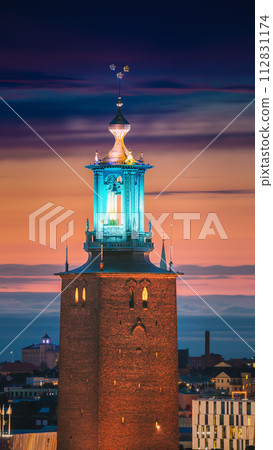 Stockholm, Sweden. Close View Of Famous Tower Of Stockholm City Hall. Popular Destination Scenic In Sunset Twilight Dusk Lights. Evening Lighting Stockholm, Sweden. Close View Of Famous Tower Of Stockholm City Hall. Popular Destination Scenic In Sunset Twilight Dusk Lights. Evening Lighting 112831174