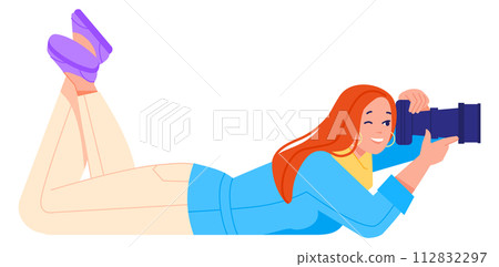 Woman making photo laying on ground. Professional photographer 112832297