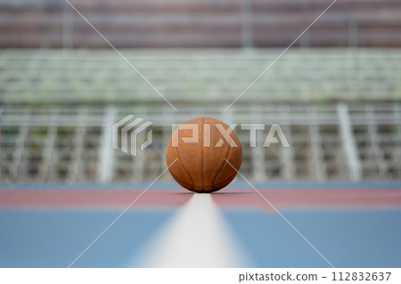 Basketball on floor in the center of the stadium. Sport, training and competition concept Basketball on floor in the center of the stadium. Sport, training and competition concept 112832637
