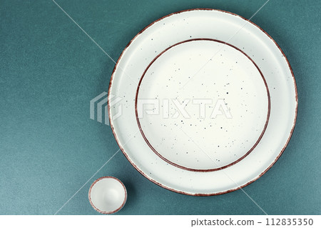 Empty plates on the table 112835350