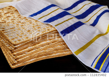 Passover celebration setting table with matzah bread for Jewish holiday Passover celebration setting table with matzah bread for Jewish holiday 112835402