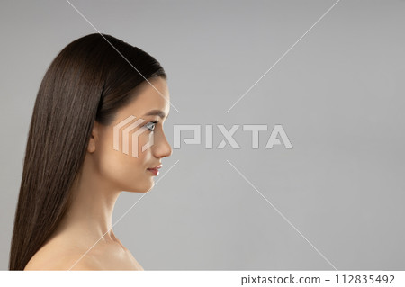Attractive young girl on a gray background. Botox concept 112835492
