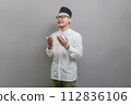 Asian Muslim man standing looking empty space happily to show grateful 112836106