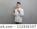 Asian Muslim man standing looking empty space happily to show grateful 112836107