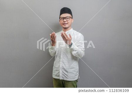 Asian Muslim man standing looking empty space happily to show grateful 112836109