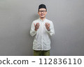 Asian Muslim man standing looking empty space happily to show grateful 112836110