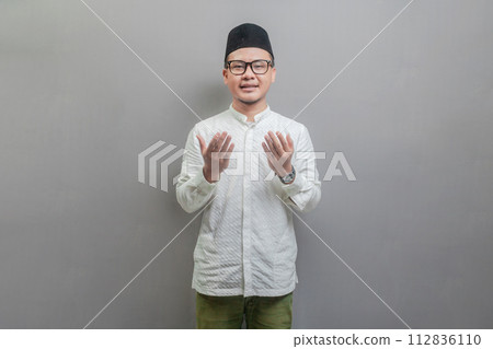 Asian Muslim man standing looking empty space happily to show grateful 112836110