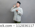 Happy asian muslim man drinking a fresh glass of pure water 112836117