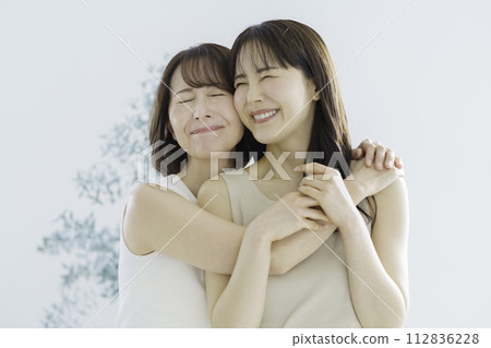 Mother and daughter portrait of daughter and mom in their 30s Mother and daughter portrait of daughter and mom in their 30s 112836228