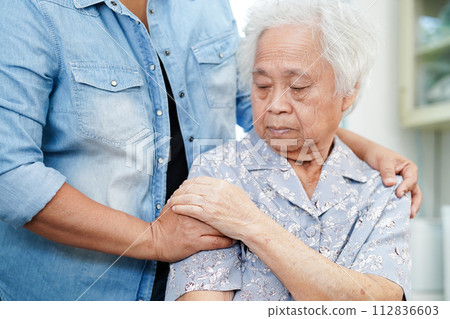Caregiver taking care, help and encourage Asian elder senior woman patient in clinic hospital. Caregiver taking care, help and encourage Asian elder senior woman patient in clinic hospital. 112836603