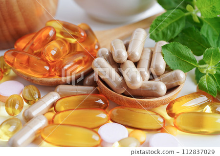 Alternative medicine herbal organic capsule with vitamin E omega 3 fish oil, mineral, drug with herbs leaf natural supplements for healthy good life. 112837029