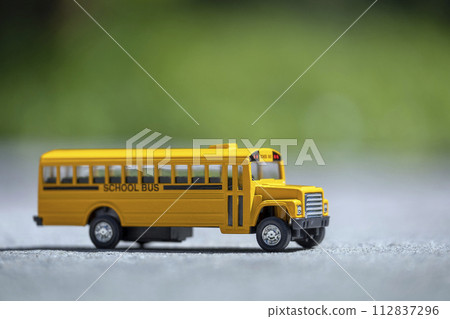 Model of classical american yellow school bus for transporting of kids to and from school every day. Concept of education in the USA Model of classical american yellow school bus for transporting of kids to and from school every day. Concept of education in the USA 112837296