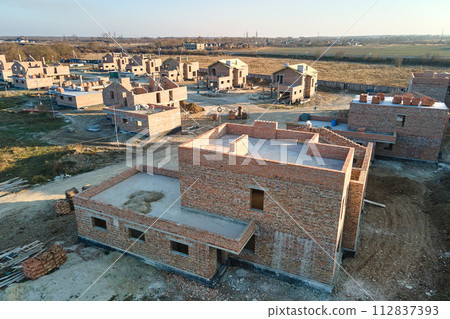 Aerial view of residential houses under construction in rural suburban area. Real estate development 112837393