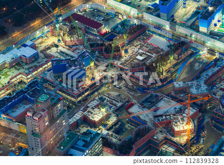 Aerial view of busy industrial construction site workers with cranes working. Top view of development high rise architecture building. 112839328