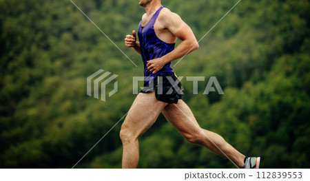 close-up man athlete running in background of green forest 112839553