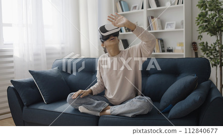 Surprised girl wearing virtual reality headset, 3d world experience, technology Surprised girl wearing virtual reality headset, 3d world experience, technology 112840677