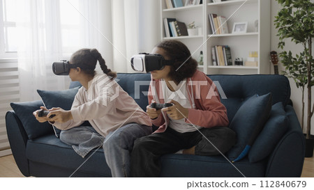 Joyful teen friends in vr glasses enjoying video game together, youth leisure Joyful teen friends in vr glasses enjoying video game together, youth leisure 112840679