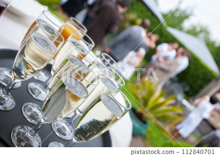Toast to Joy: Sparkling Champagne Awaits Guests at a Garden Soiree Toast to Joy: Sparkling Champagne Awaits Guests at a Garden Soiree 112840701