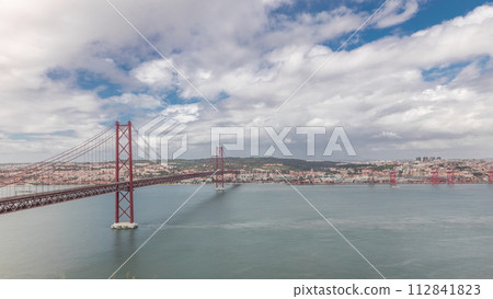 Panorama showing Lisbon cityscape and Tagus river timelapse with 25 of April bridge 112841823